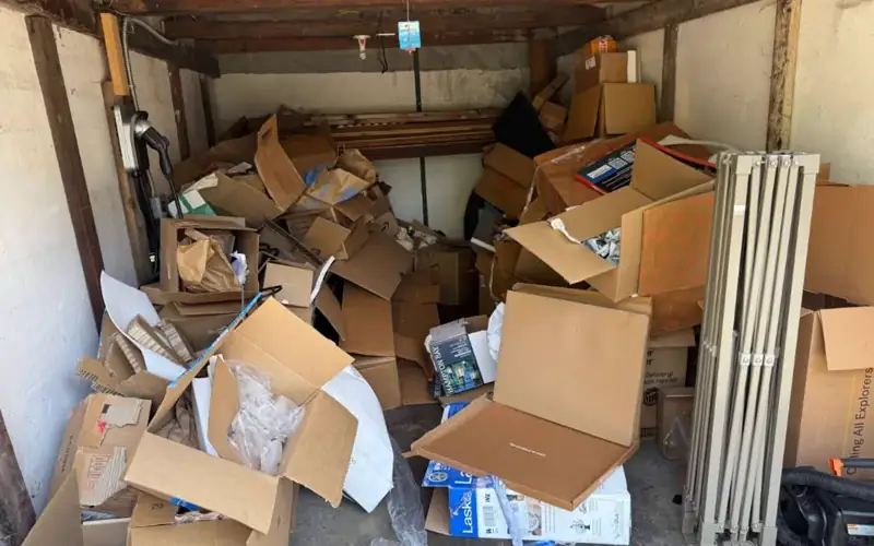 A customer's garage packed with boxes and junk before Breath Out