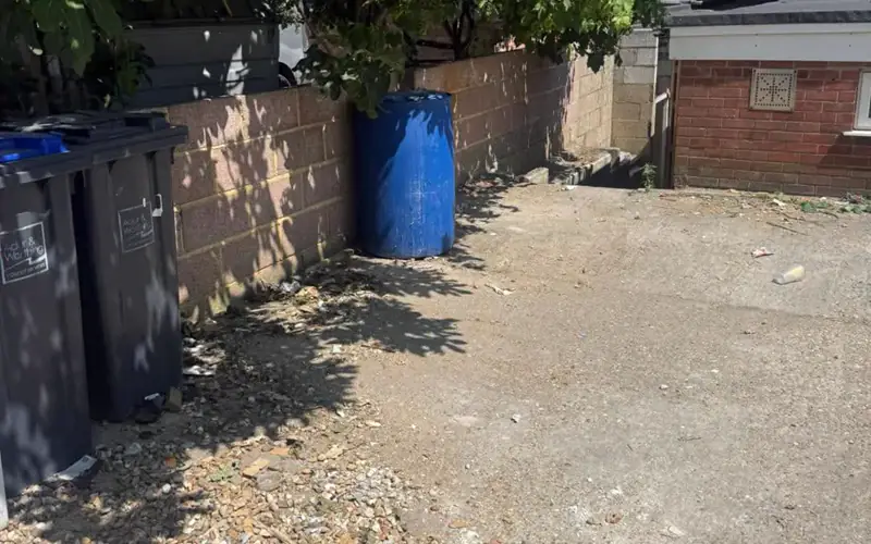 The same side yard cleared and swept after Breath Out hauled everything